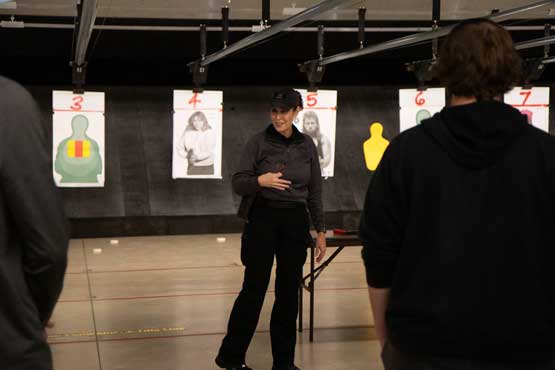ATCC-Open-House-Fall2025_2928 Police officer speaking to group of guests in shooting range