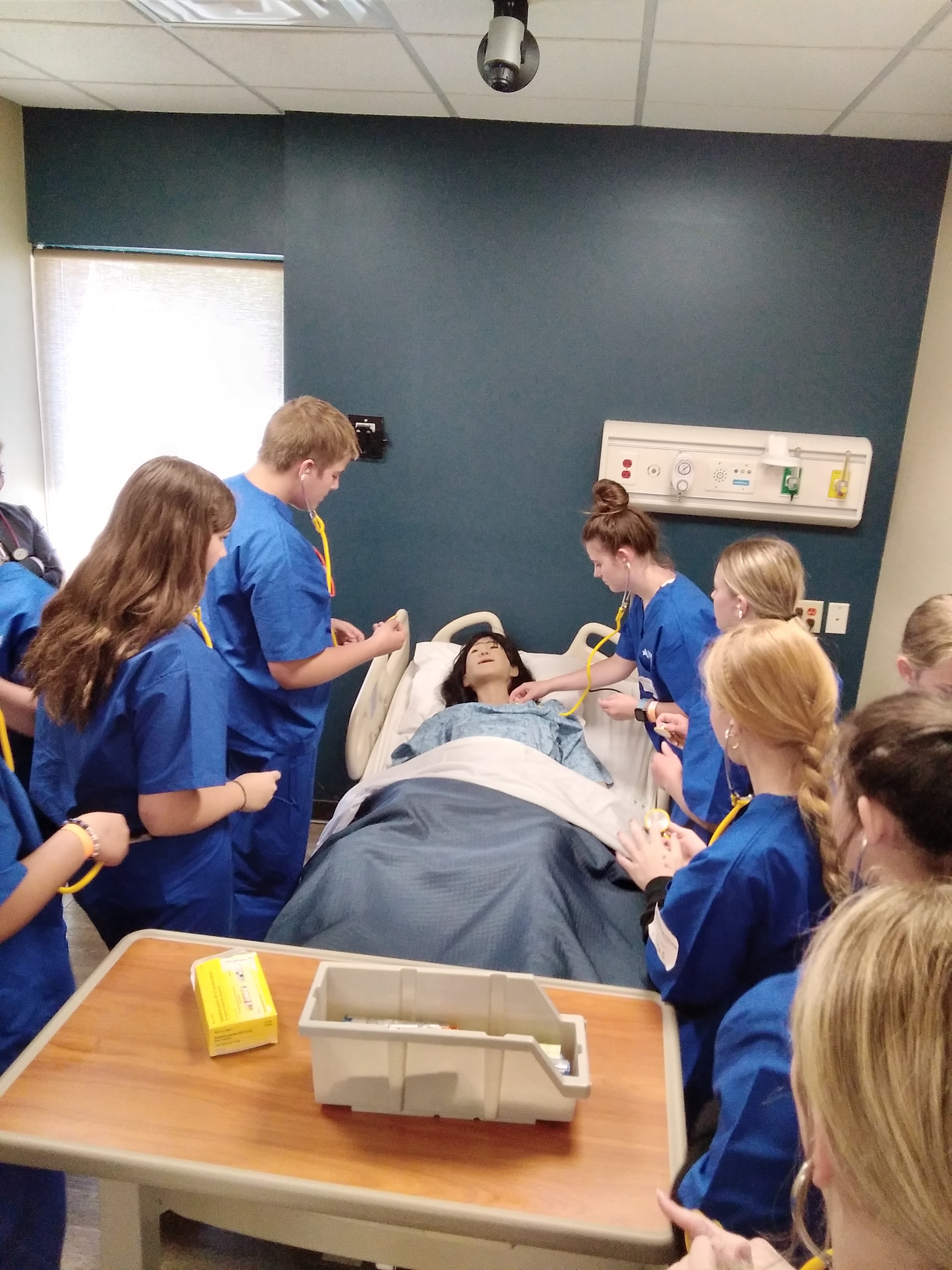 Students practicing skills on a mannequin