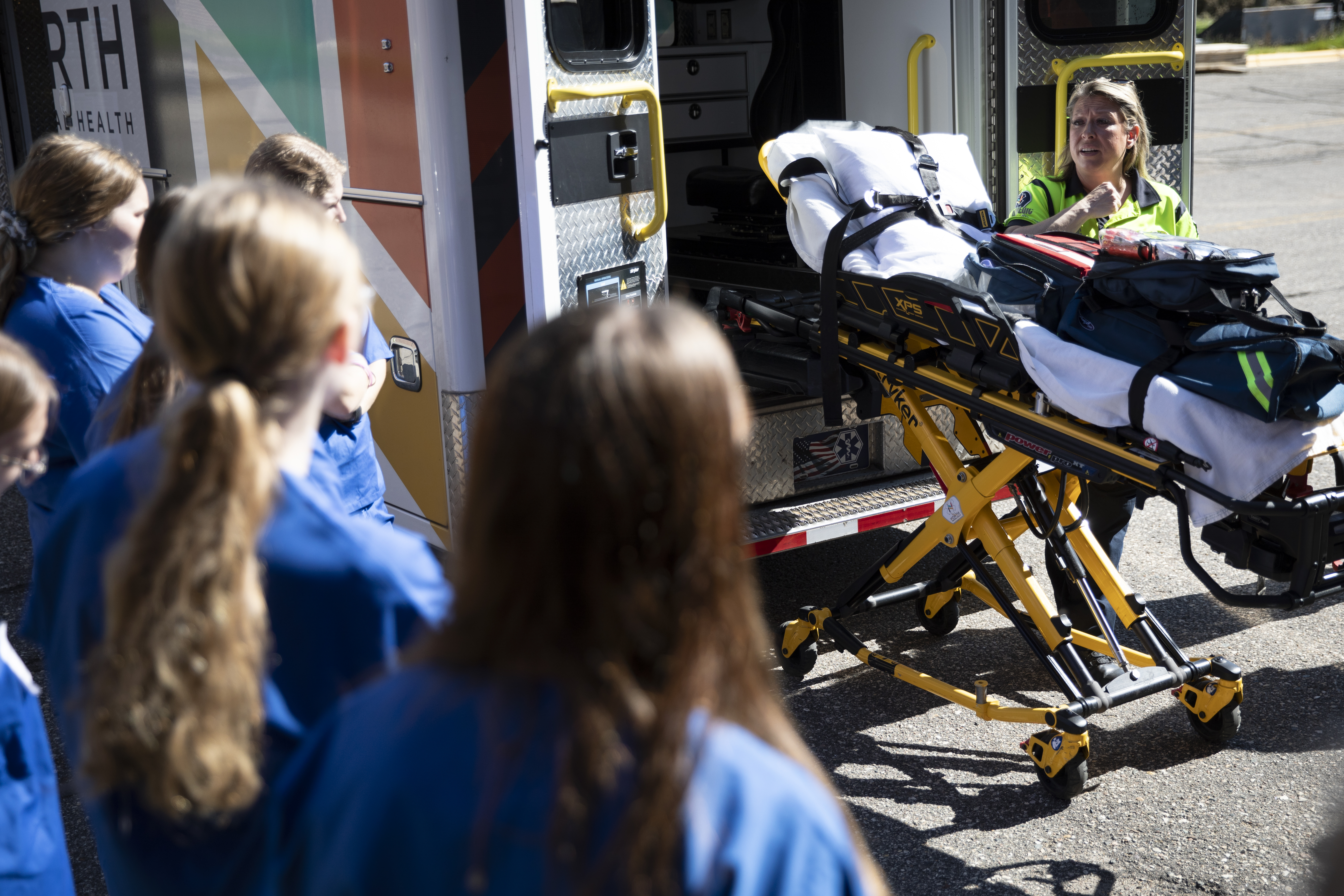 Students watching a demonstration given by an EMT
