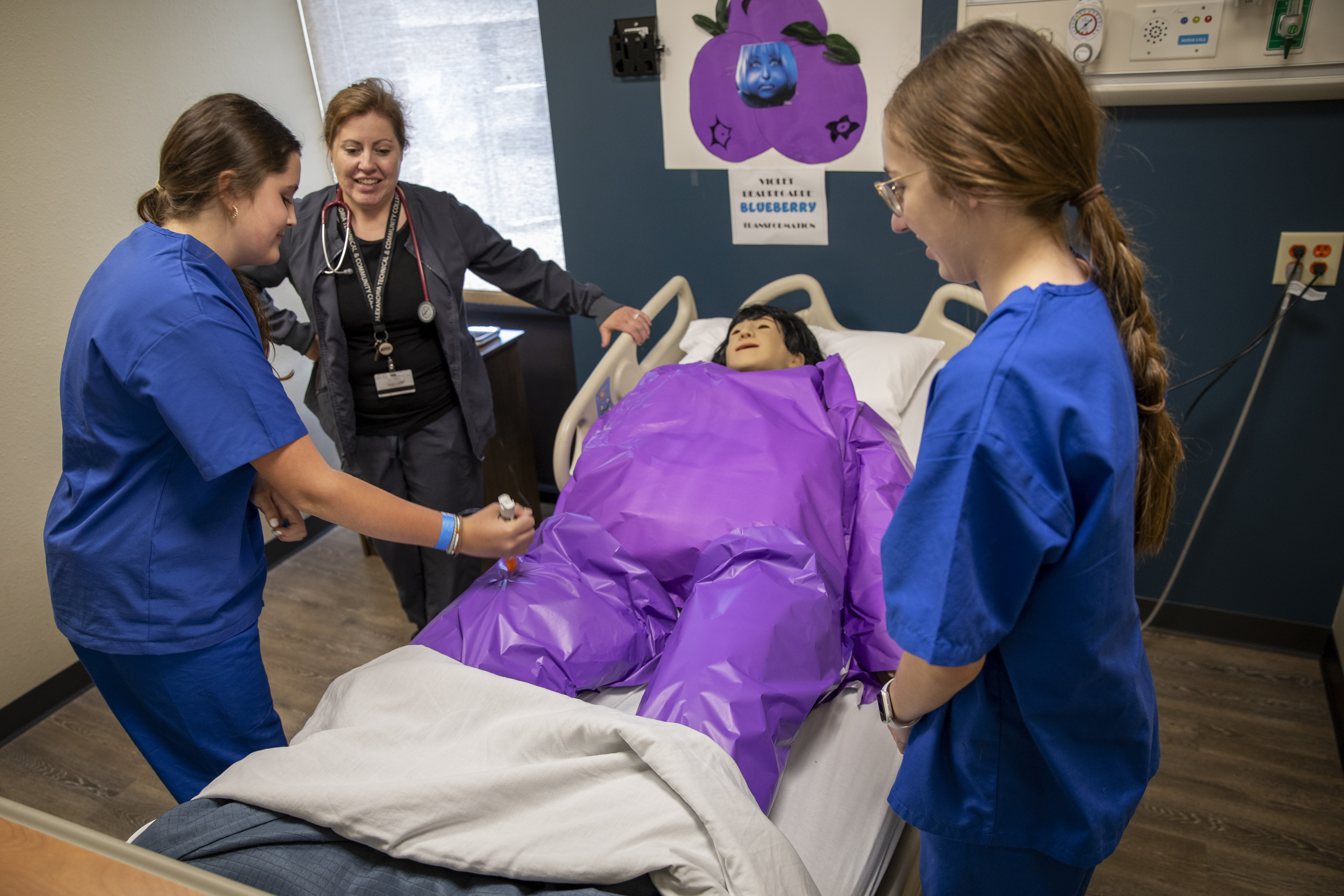 Students practicing skills on an mannequin