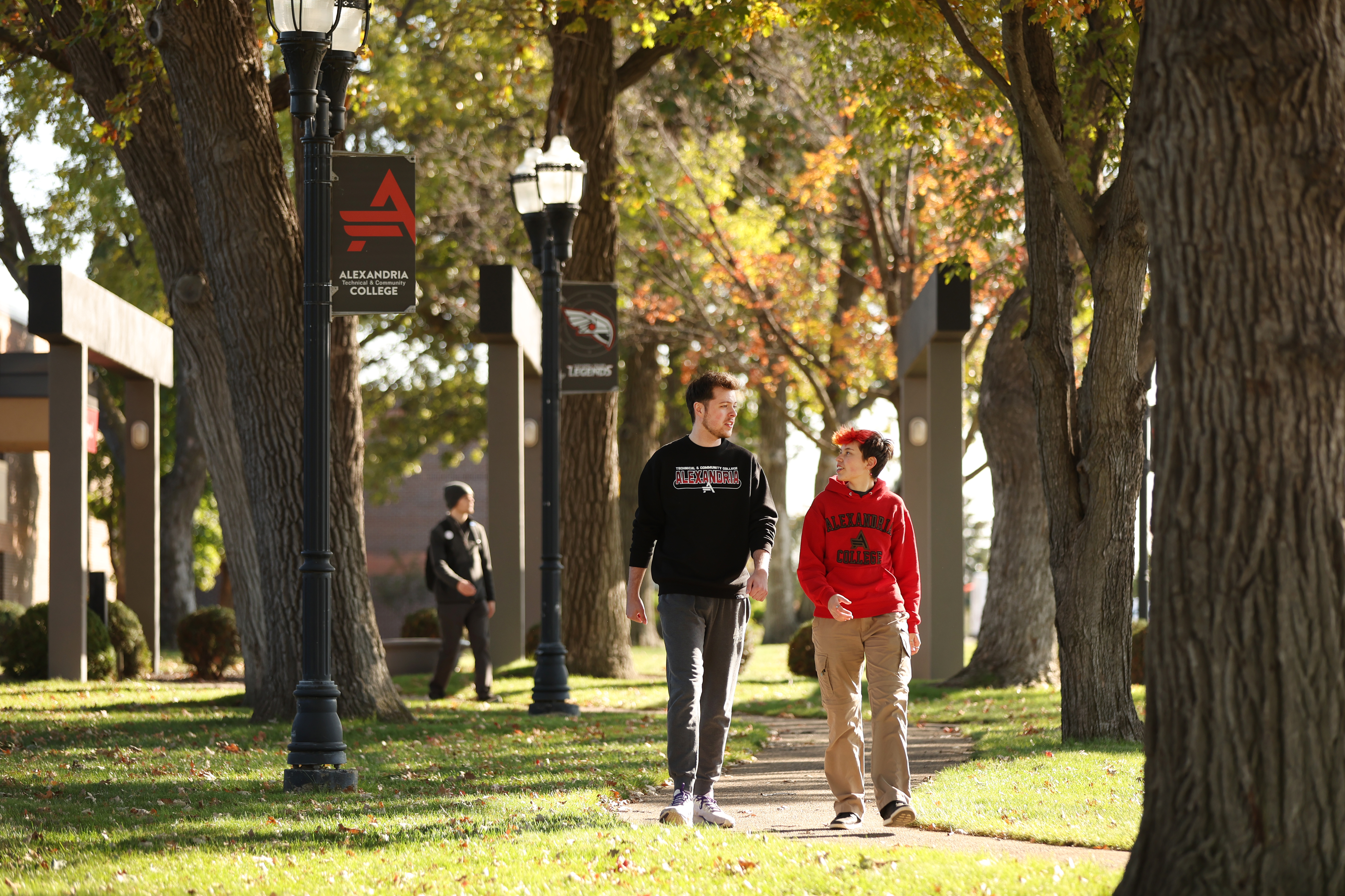 Two ATCC students walk outside a campus building