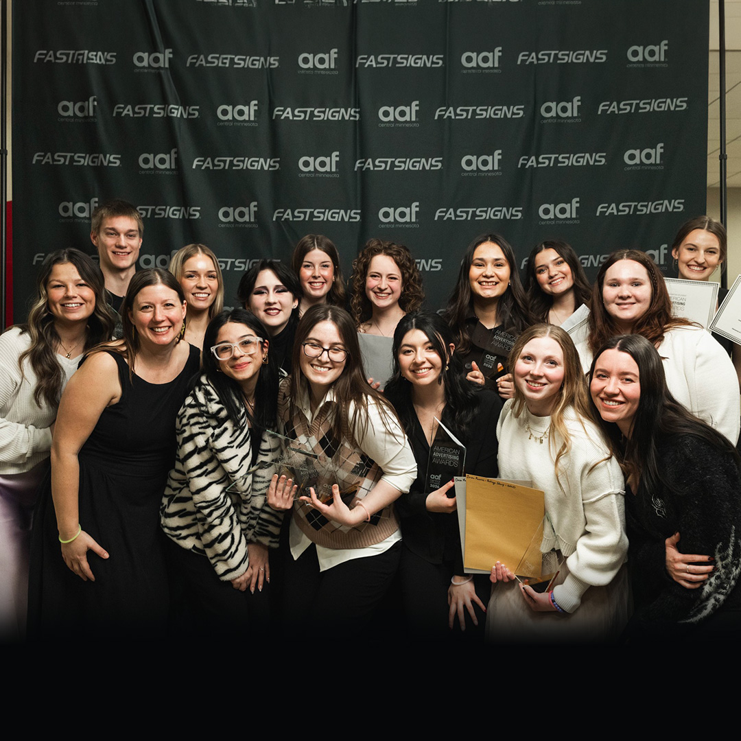 Group of Communication Design students and instructors holding their awards