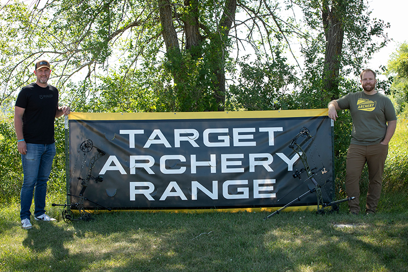 Tyler Notch, Alexandria Technical and Community College new assistant archery coach, and Dan Gates, new head coach, pose for a photo at Alexandria Shooting Park, Alexandria Minn.