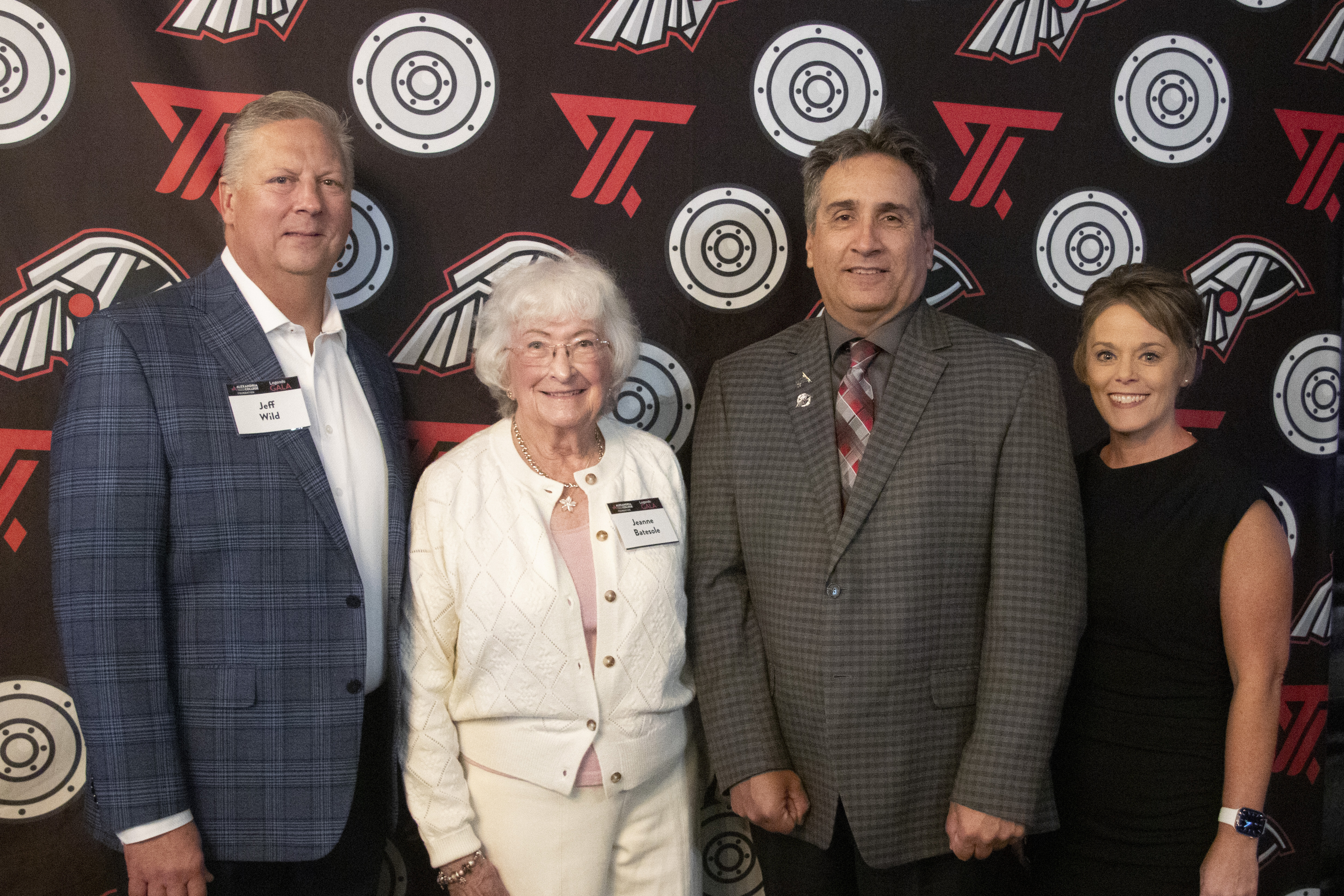 Four individuals in cocktail attire stand in front of an ATCC-branded backdrop