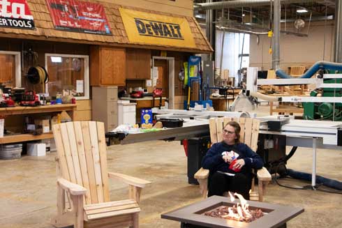 ATCC-Open-House-Fall2025_3096 Campfire with woman seating in chair by the fire