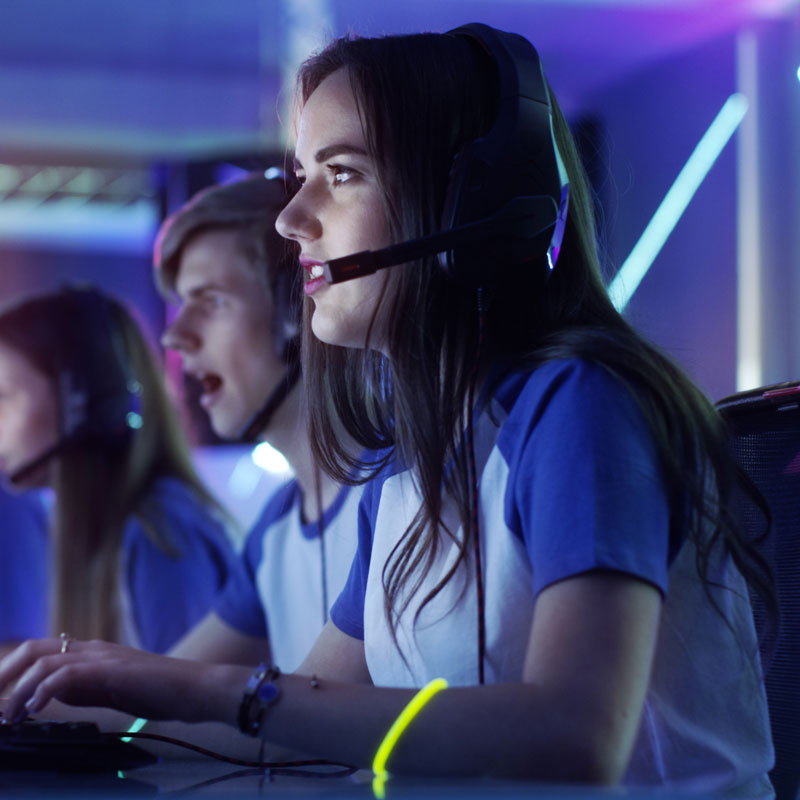Girl with headset on playing a computer game
