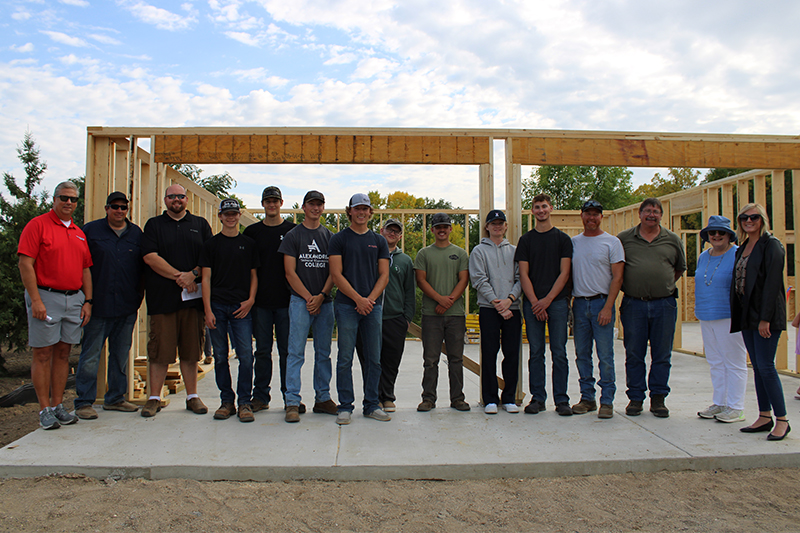 ATCC Carpentry Students and school officials pose for a photo with volunteers from the Habitat for Humanity of Douglas County organization during the blessing of the Legends Build project home.