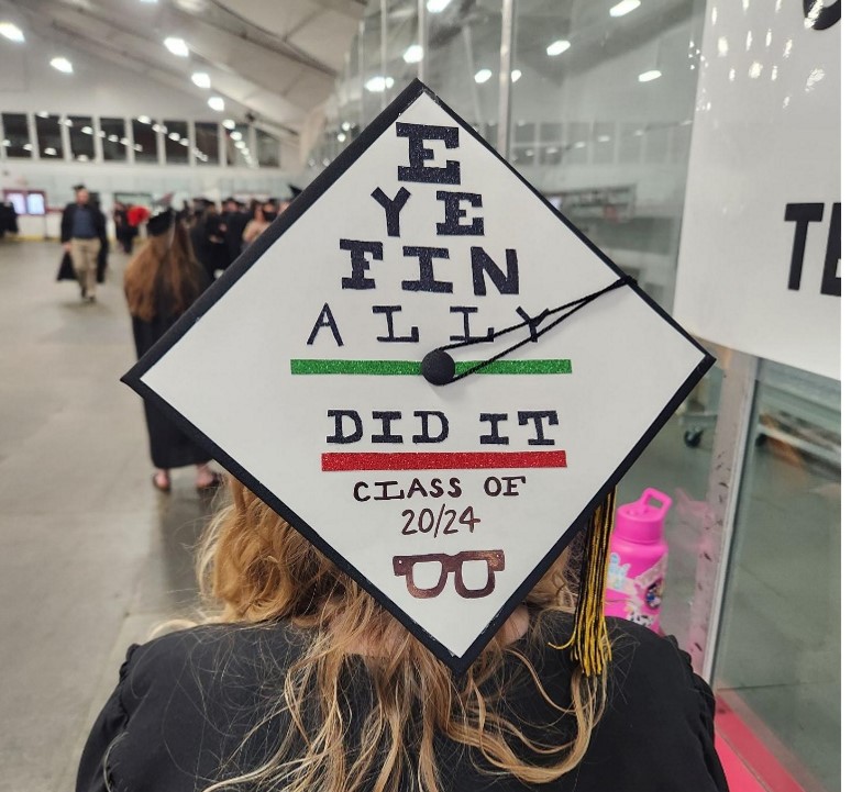 Graduation cap of Ophthalmic Medical Technician student that looks like an eye chart and says "Eye Finally Did It - Class of 20/24"