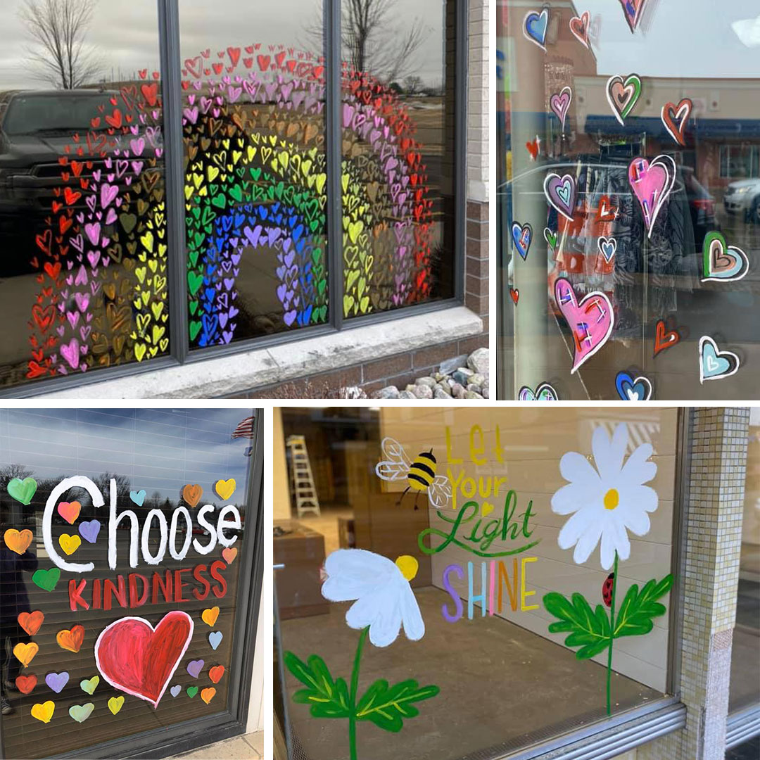 Hearts and inspirational messages painted on windows of area businesses