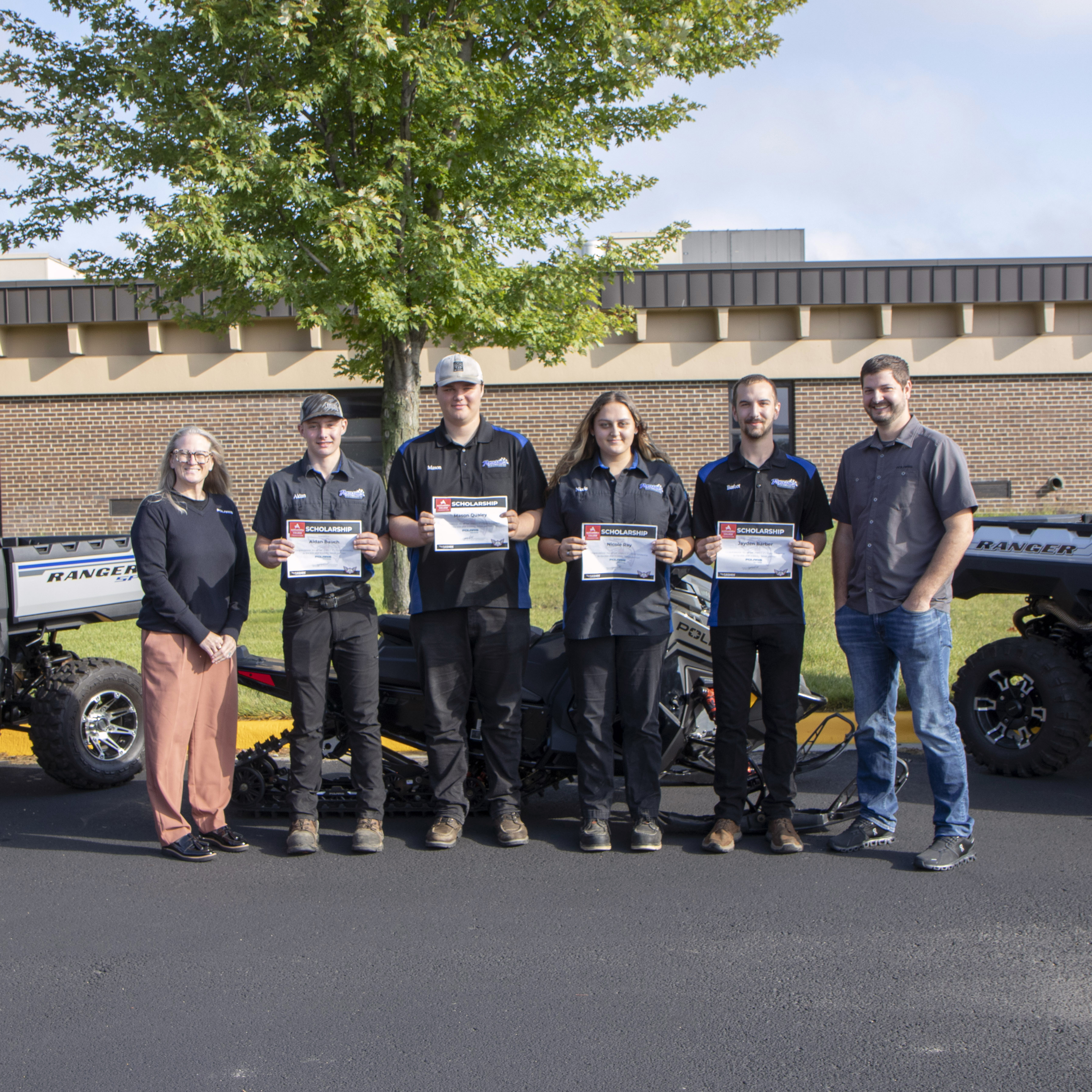4 Powersports Students holding scholarship certificates