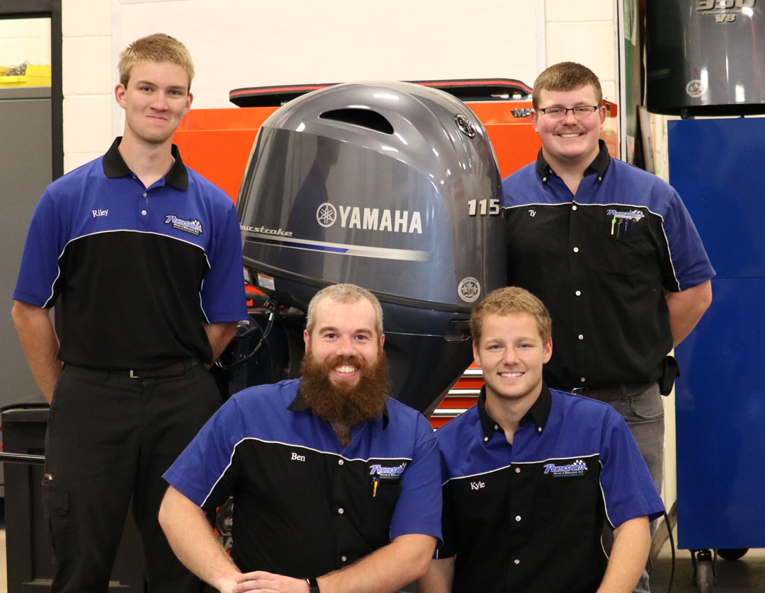 Powersports students pose with donated outboard motor