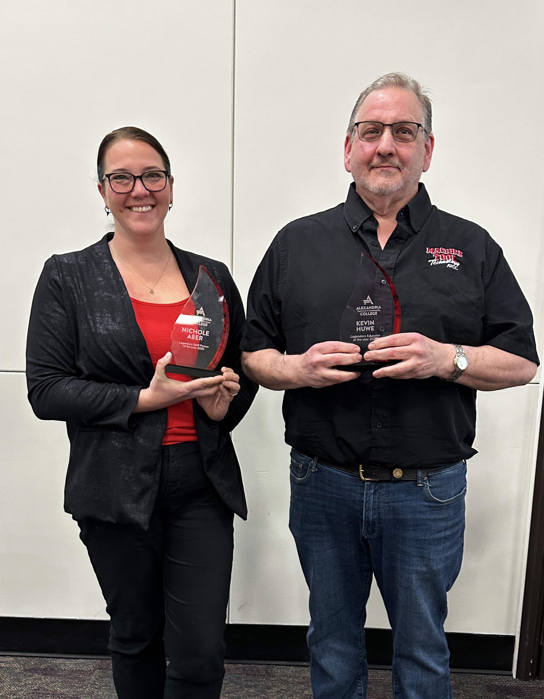 Nichole Aber and Kevin Huwe holding Legendary Employee Awards